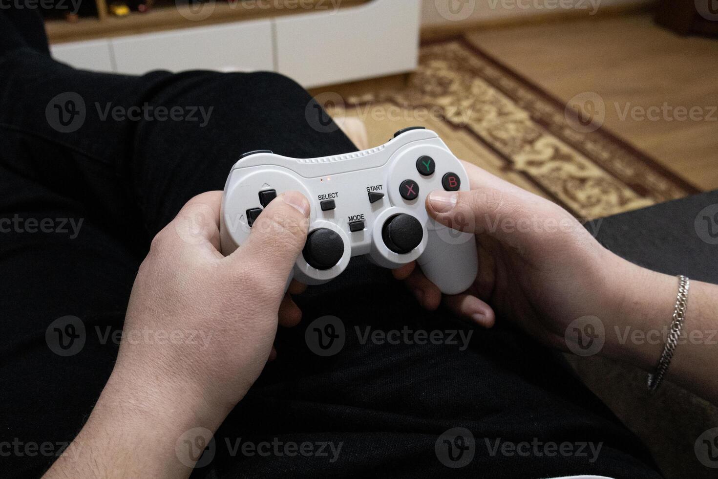 Playing game on console. Gaming game play on tv monitor. Gamer concept. Young boy hand with joystick at home photo