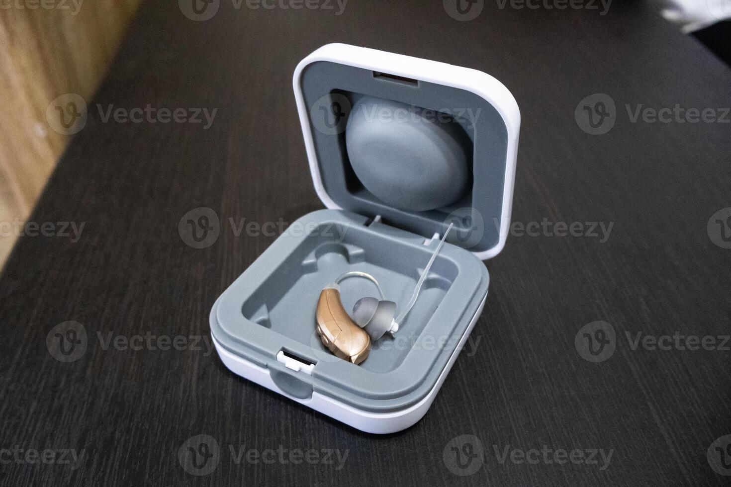 Hearing aid in grey cover on the table photo