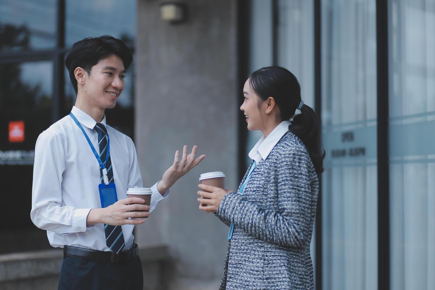 Two young people talking outside an office building photo