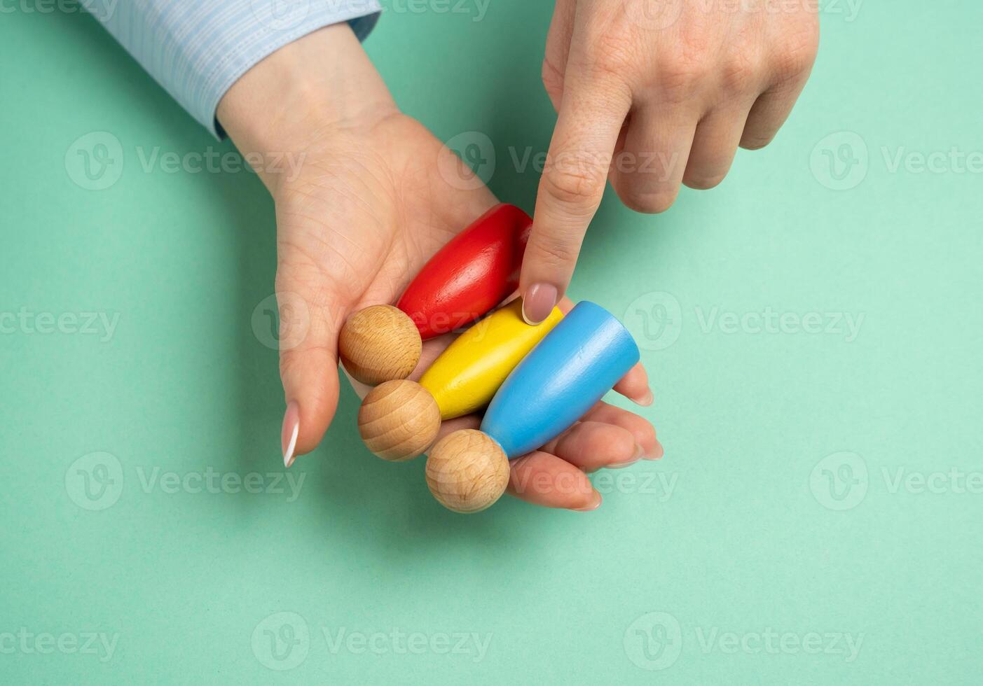 A woman chooses people on her palm. The concept of task delegation, selection of suitable workers for the task. Finding the right people for a project. Employee recruitment, photo
