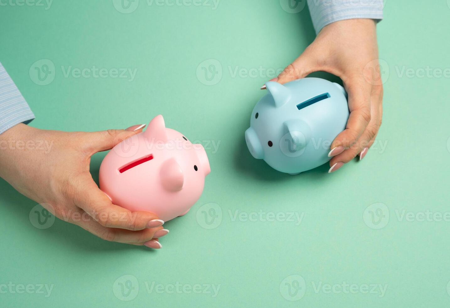 Two piggy banks of different sexes in hands. Concept of financial relations in a couple or family. Common or separate budget for spouses. Financial dynamics in relationships. Household budgets. photo