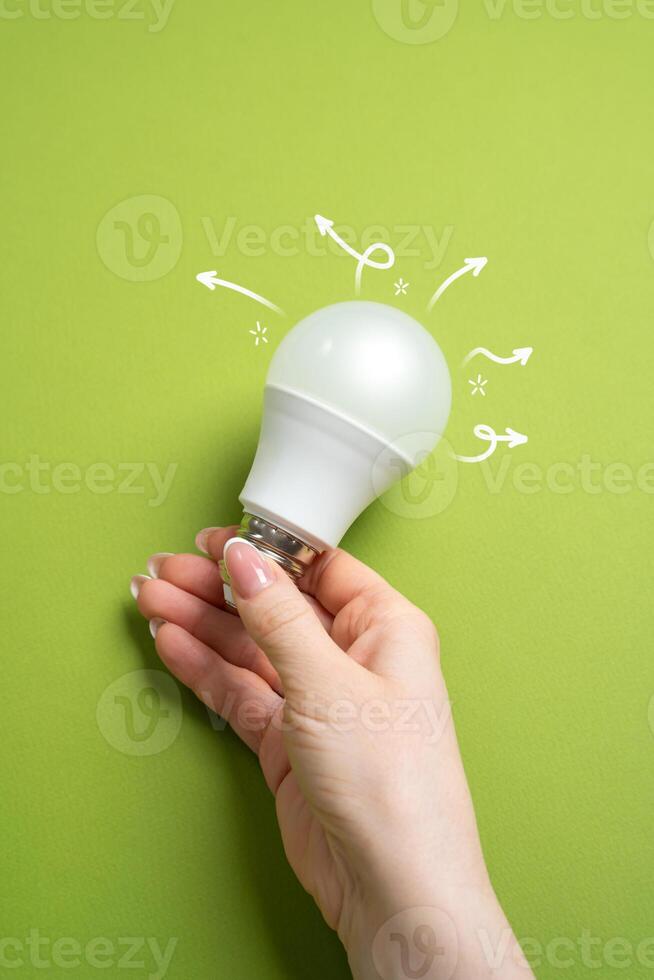 Idea and motivation for development. Light bulb in hand. Creativity, and innovation. Achieving success through inspired thinking. photo