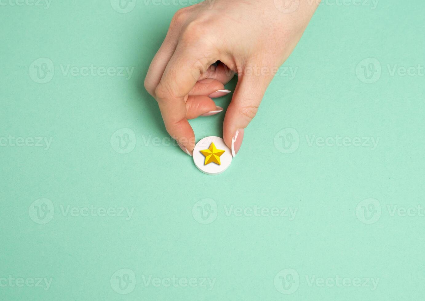 The hand holds a gold star. Distinction. Rating and recognition. Achievement. Top ratings in professional or educational settings. photo