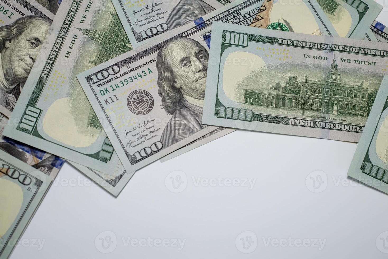 Stacks of hundred dollar bills arranged creatively on a flat surface for marketing photo