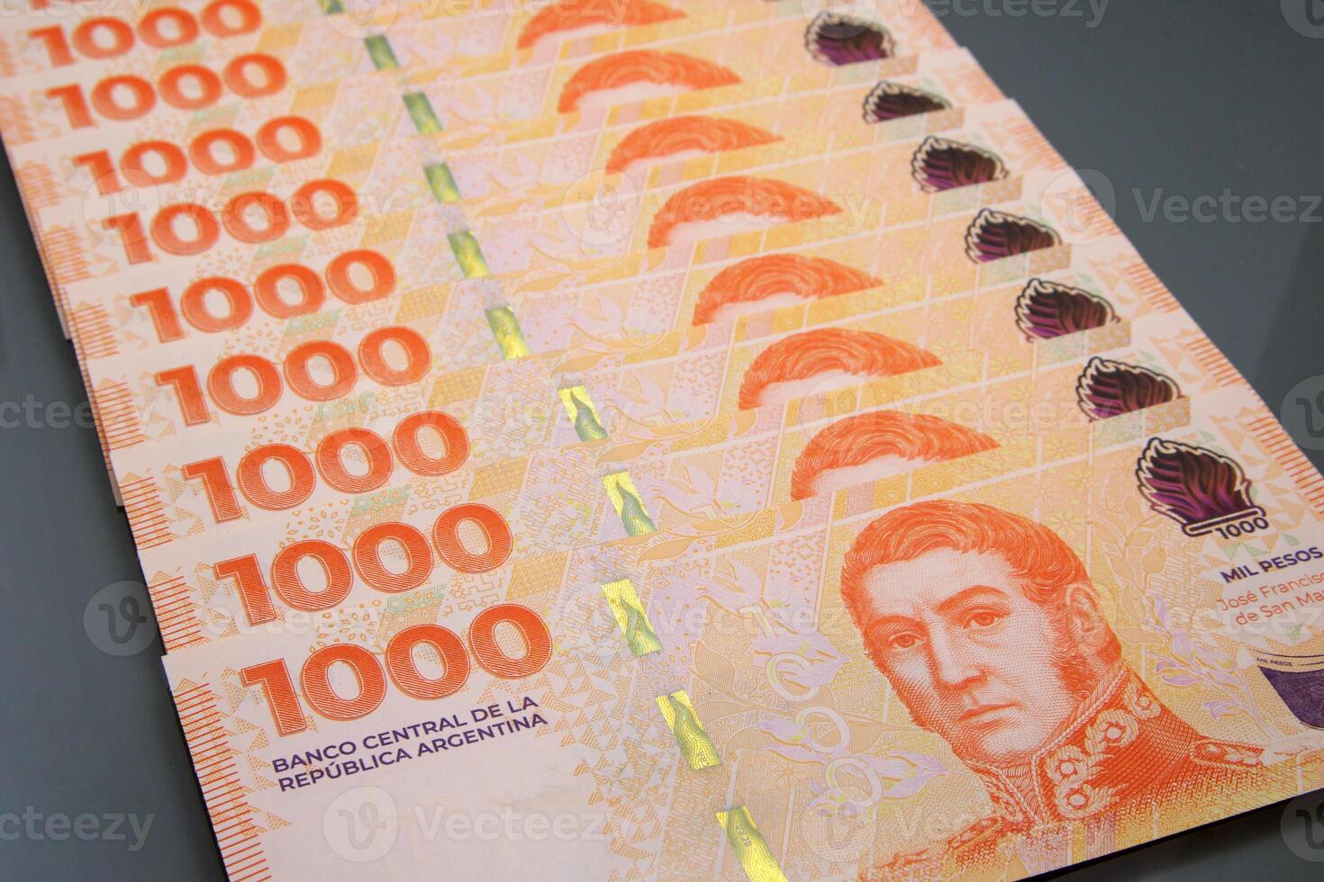 Stack of Thousand Pesos Banknotes, Argentine Money on Dark Surface photo