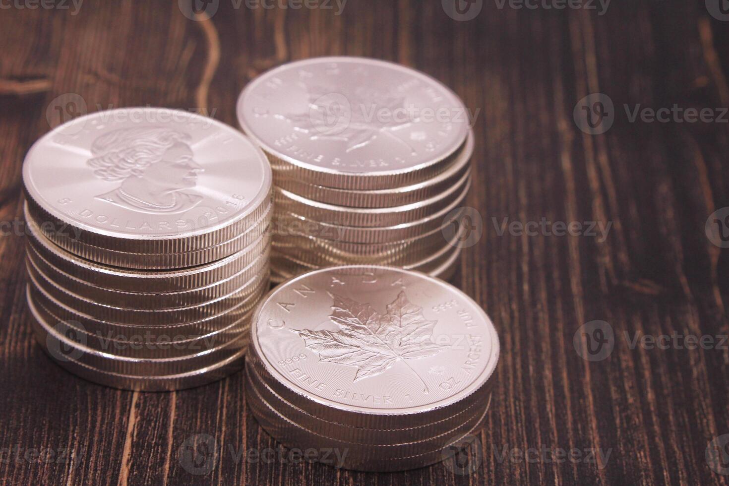Maple Leaf Coins, Canadian Silver 1 OZ Displayed on Wood photo