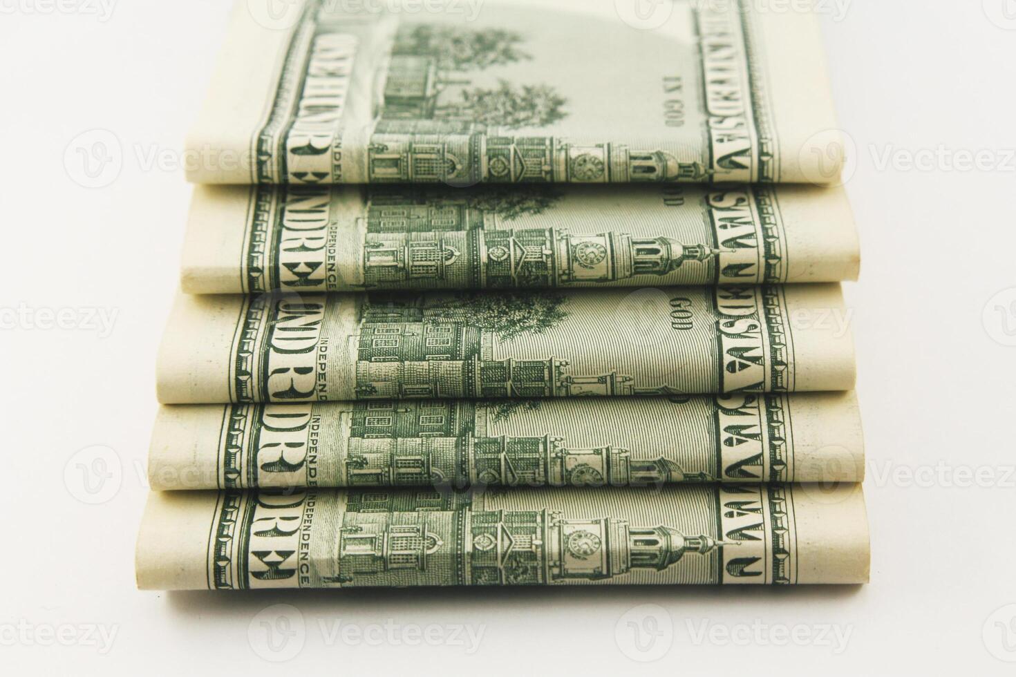 Stacks of American hundred dollar bills in cash on a dark background photo
