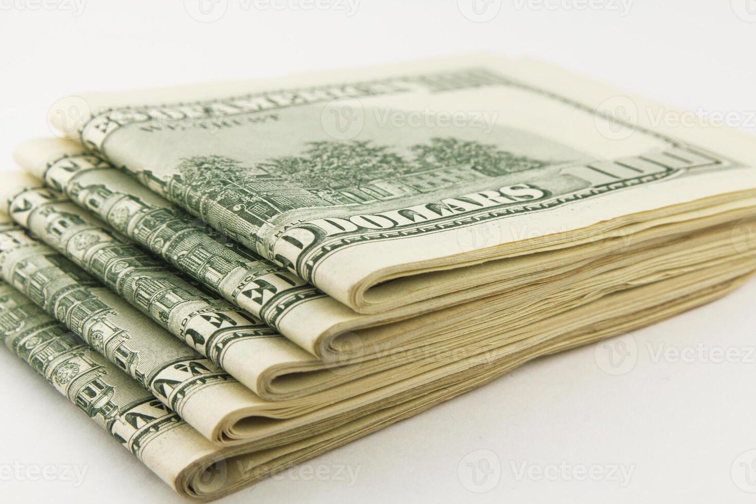 American hundred dollar bills stacked on a dark surface photo