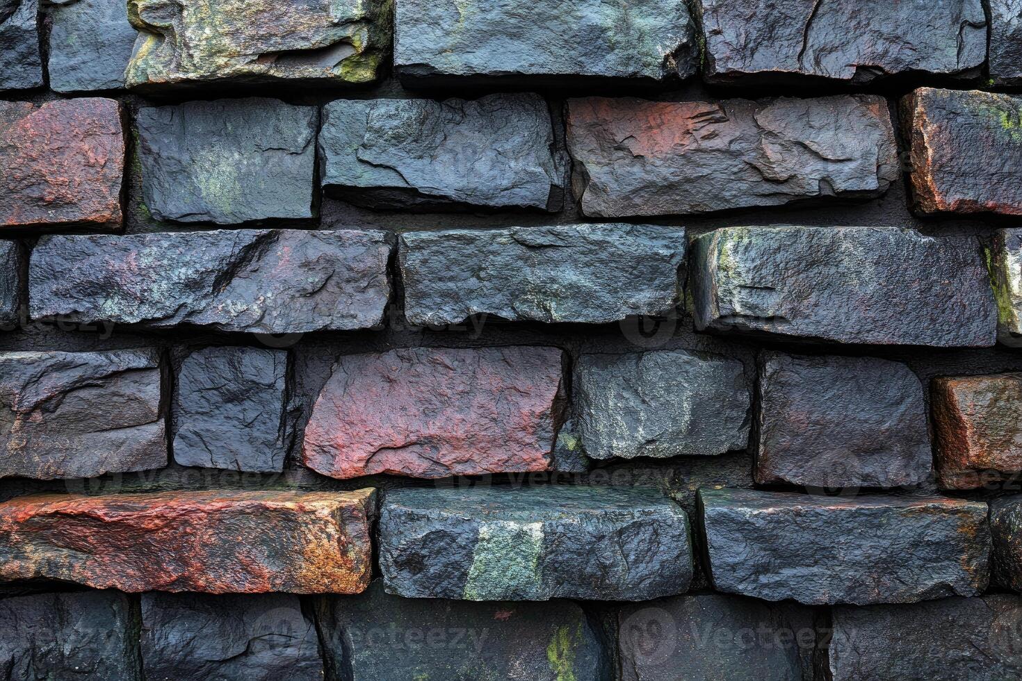A Close-Up of a Wet, Rough Stone Wall photo