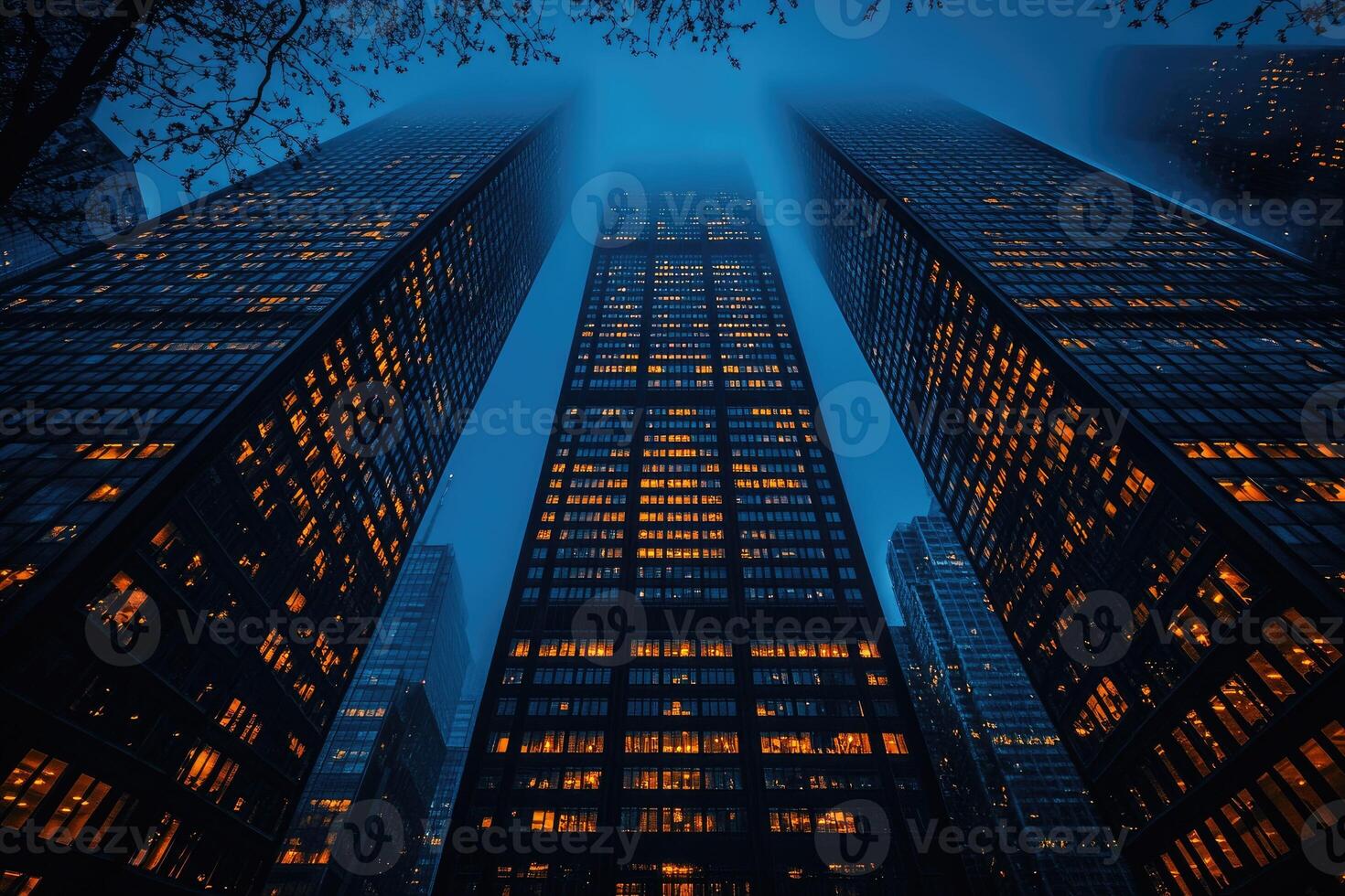 Three Skyscrapers Illuminated at Night with Fog photo