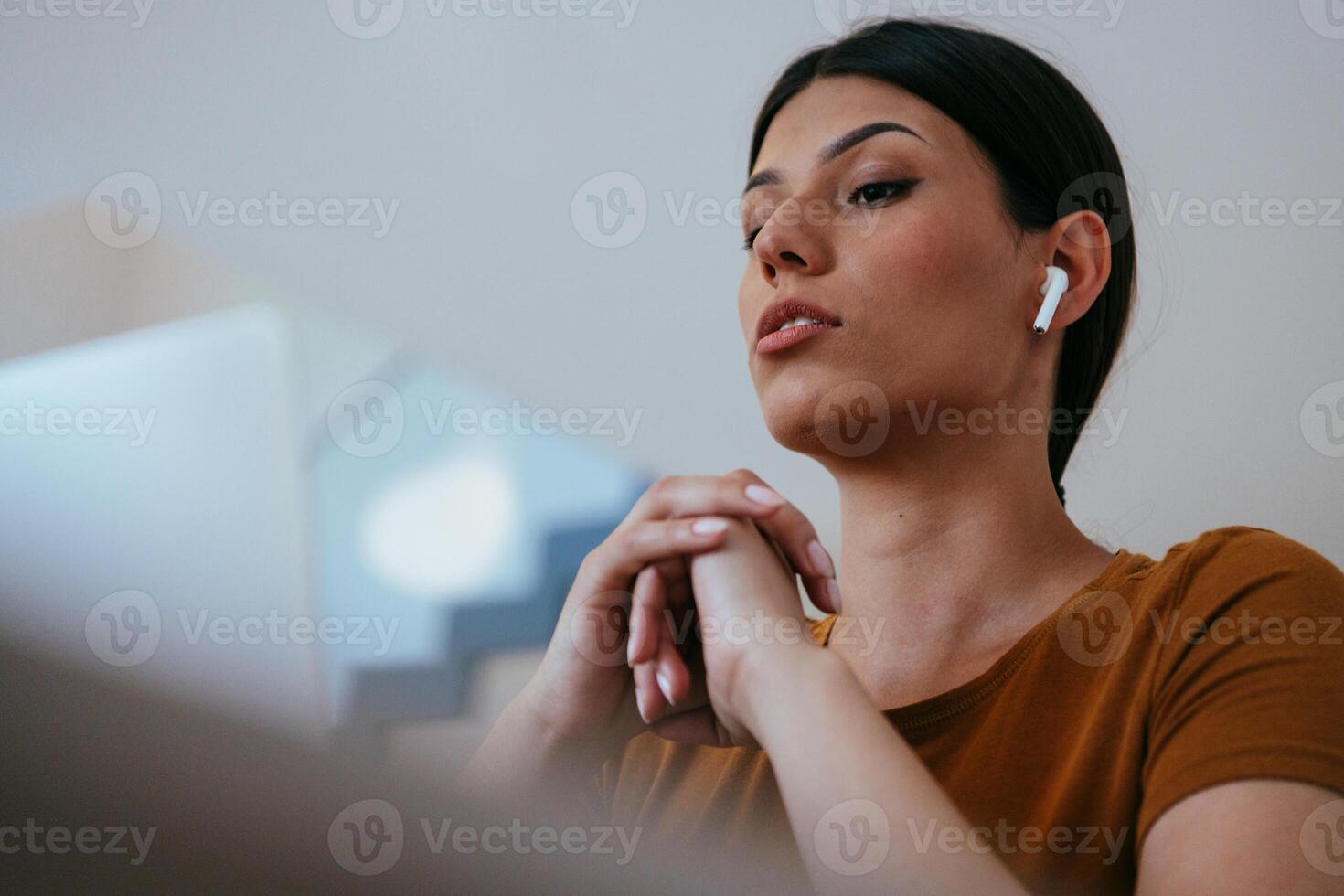 Woman sitting in living room using laptop looking at cam talk by call with business friend relatives, head shot. Job interview answering questions photo