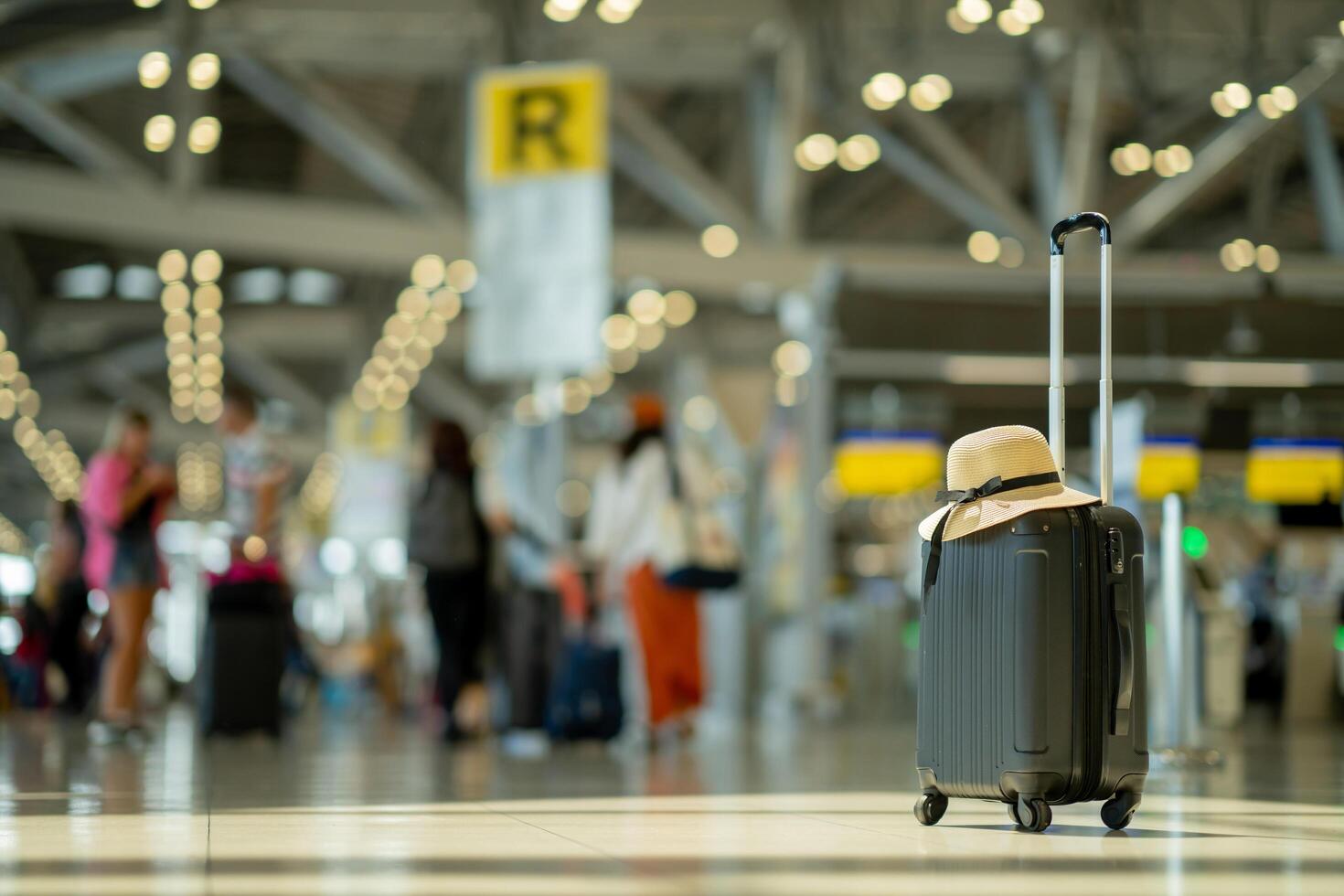 The suitcases in an empty airport hall, traveler cases in the departure airport terminal waiting for the area, vacation concept, blank space for text message or design, luggage for travel. photo