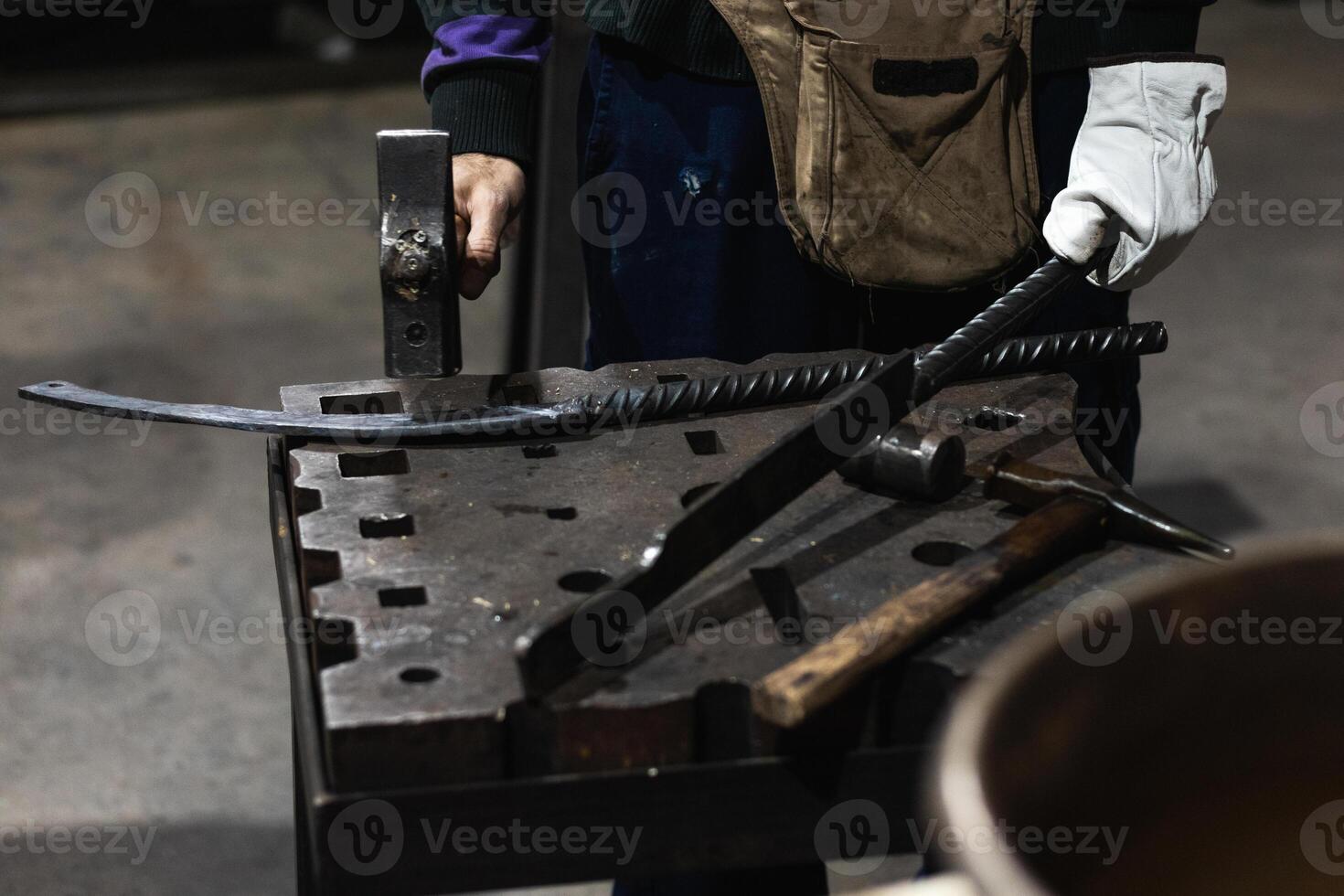Male master making metal sharp weapon photo
