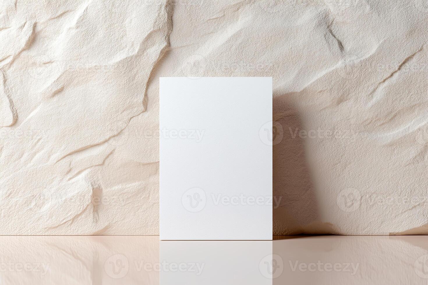 A minimalistic blank business card stands upright, leaning slightly against a softly textured wall. The background blurs gently, creating a luxurious and professional atmosphere ideal for branding photo