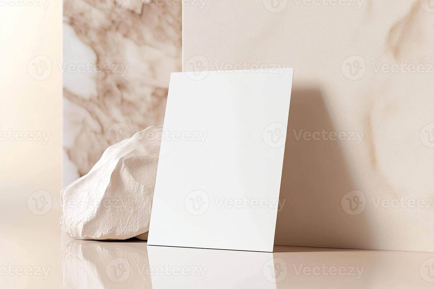 A blank business card stands upright, gently leaning against a soft-toned wall. The background features a soothing blur, enhancing its appeal for luxury branding presentation photo