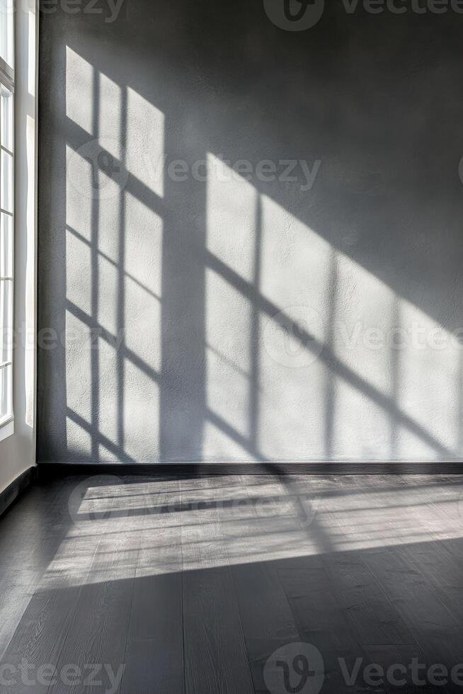 A modern space with deep charcoal walls and a matte black wooden floor, illuminated by natural light streaming through a single window. Shadows create a high-contrast, moody setting photo