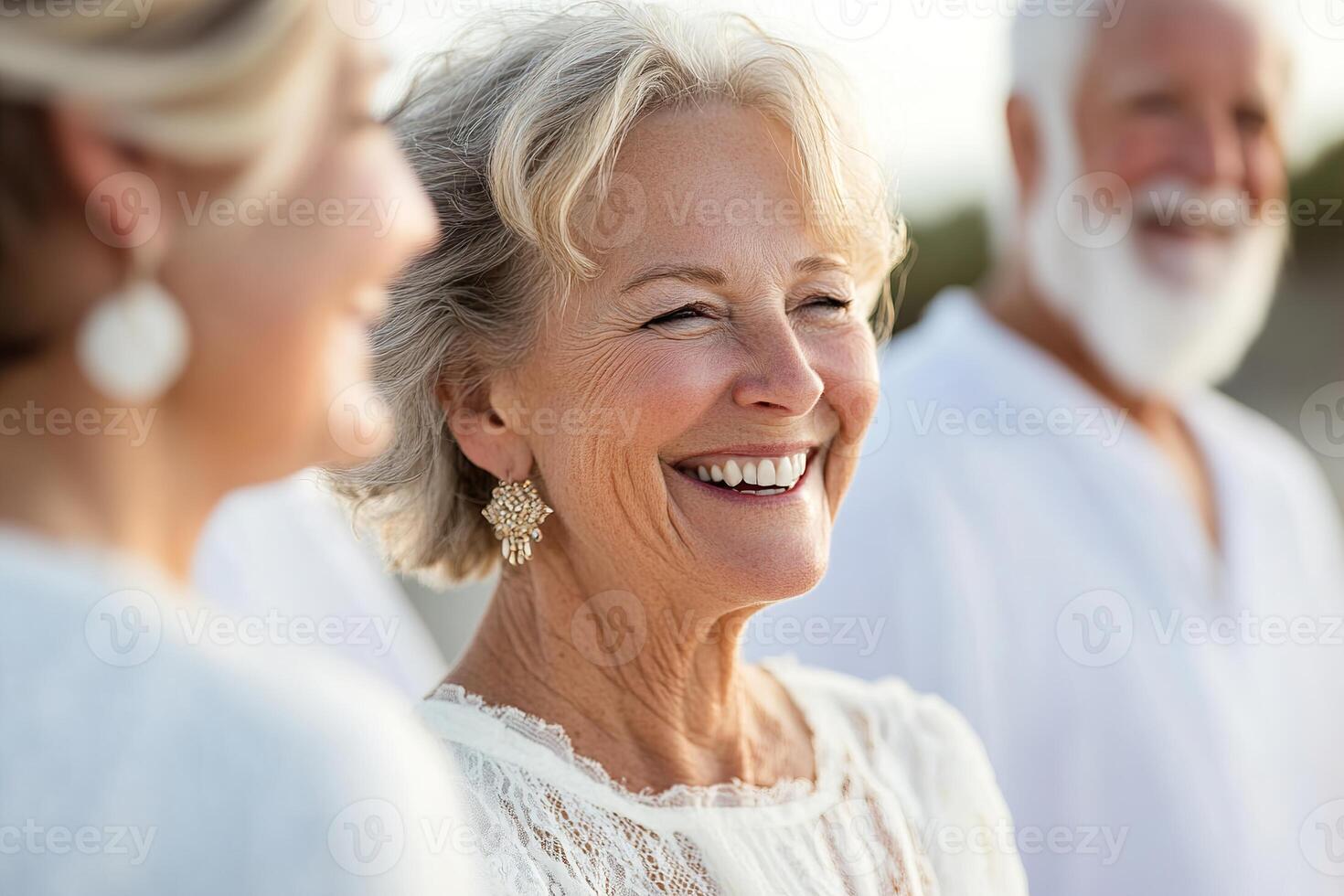 A lively group of seniors share heartfelt laughter and smiles in a sunny park, enjoying a carefree moment together. Their joyful interaction showcases a strong sense of community and connection photo