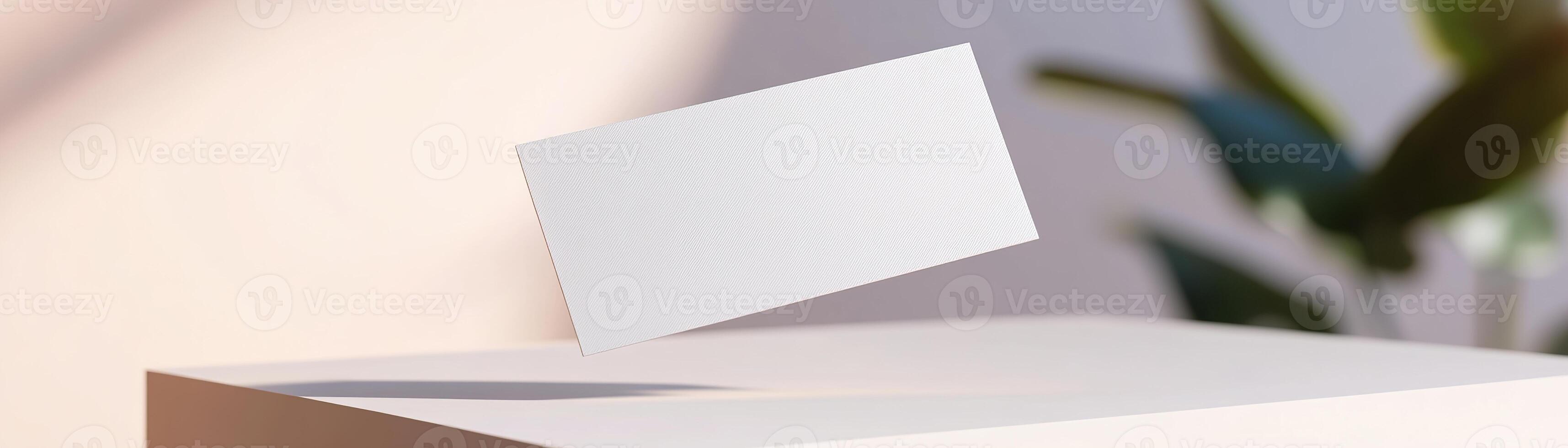 A blank business card is suspended midair, casting a gentle shadow below. The softly blurred background features a smooth gradient, enhancing the sleek look for high-end branding usage photo