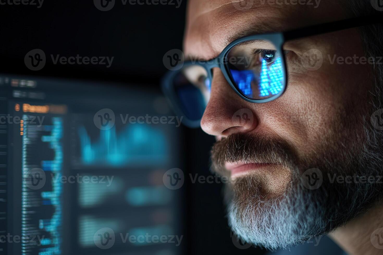 A cybersecurity expert wearing glasses focuses on assessing security threats displayed on a glowing laptop screen in a dark office. The background shows graphs and encrypted data photo