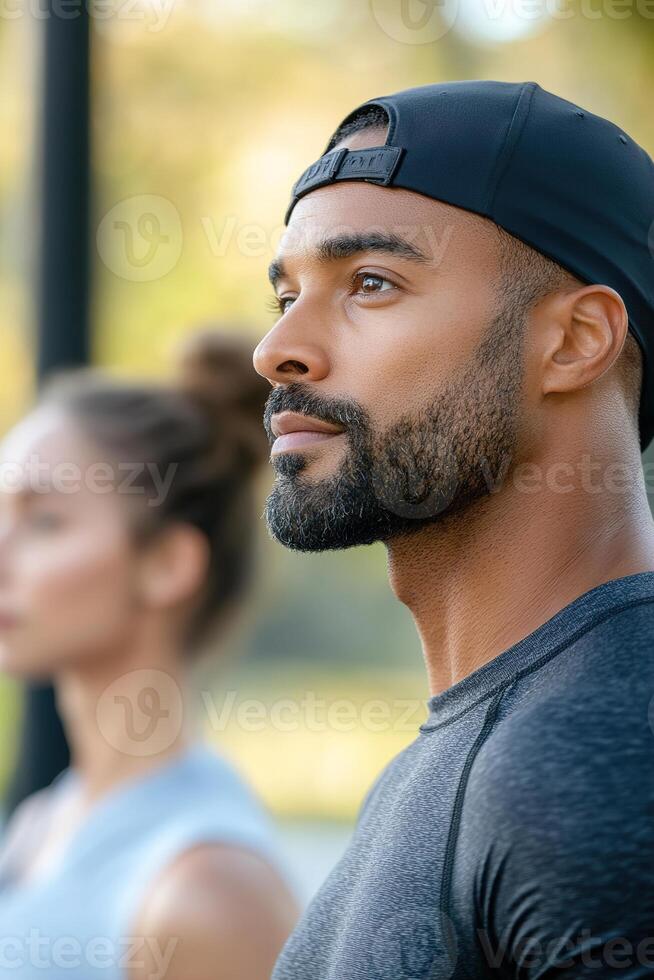 A personal trainer in activewear demonstrates exercises to a client at an outdoor fitness park. The energetic atmosphere enhances their engagement with the routine photo