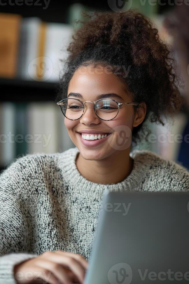 A smiling tutor assists a student through an online lesson at her desk, with an open laptop in front of her photo