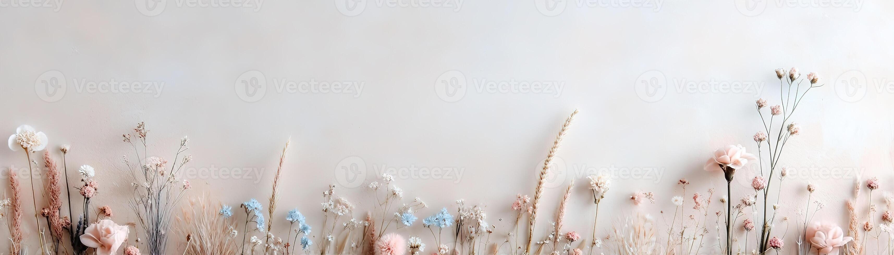 A rustic strip of meadow grass adorned with tiny colorful flowers stretches across a softly blurred pastel backdrop, ideal for floral or eco-conscious projects, leaving space for branding photo