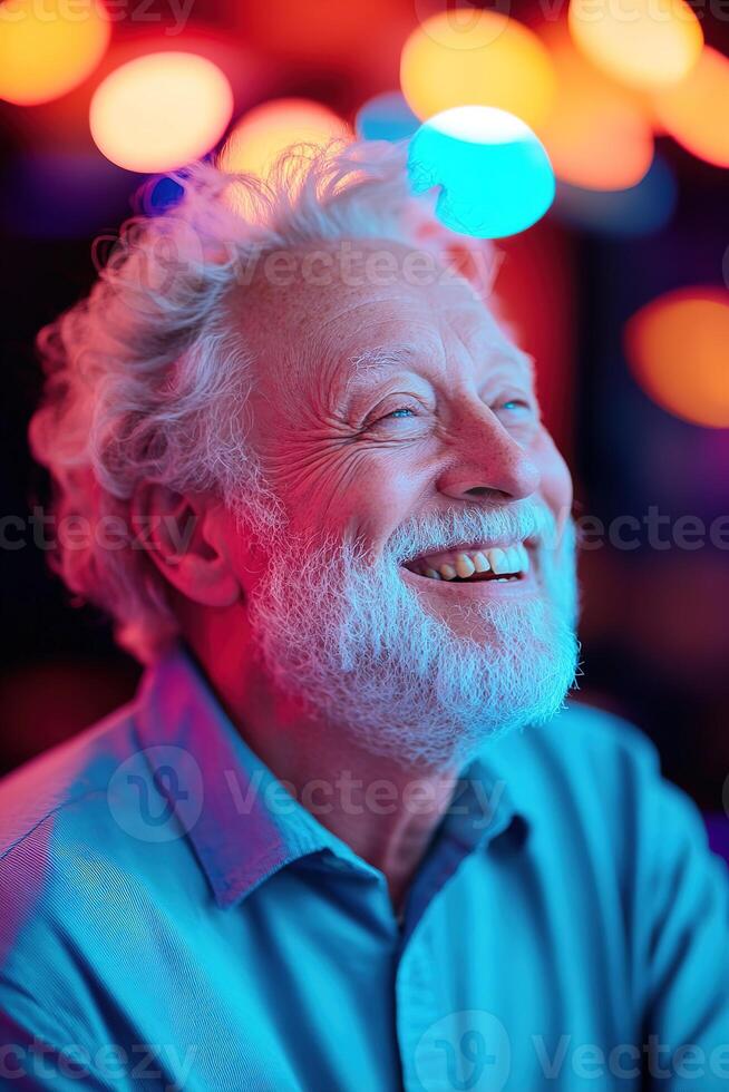 A senior man is laughing heartily while dancing on a lively dance floor. Club lights create a colorful, dreamy atmosphere, enhancing the joyful moment of celebration photo