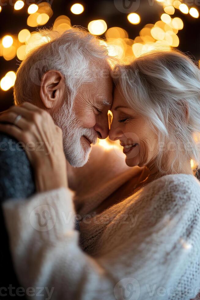 In a dimly lit nightclub, a loving elderly couple dances closely, illuminated by soft golden light. Their smiling faces radiate warmth and affection, creating a heartwarming atmosphere photo