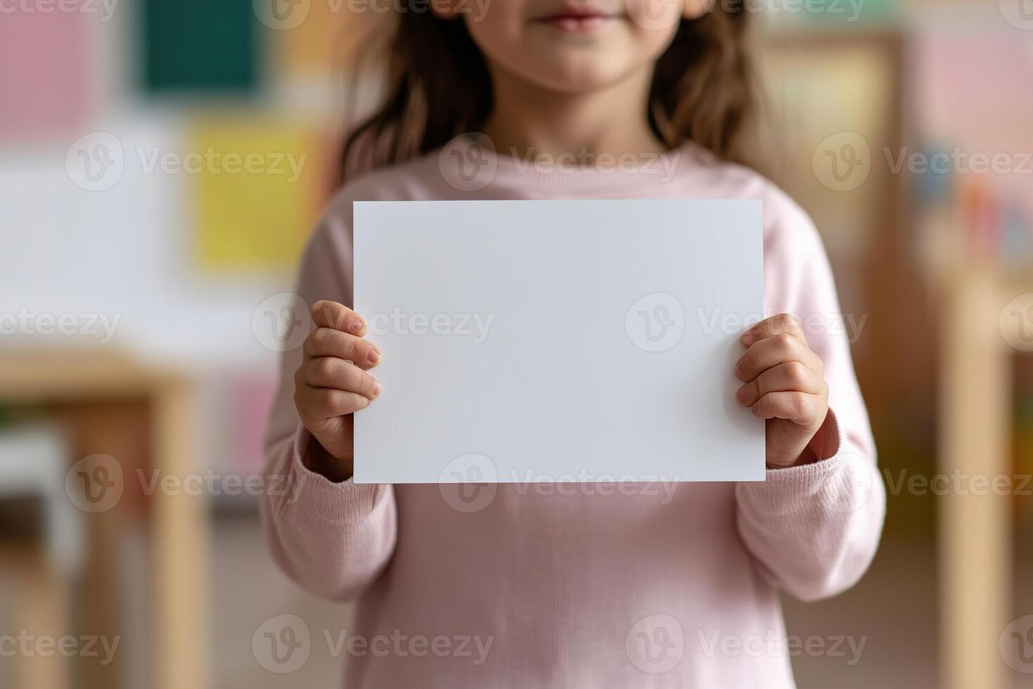 Primary school teacher enthusiastically presents a large flashcard to young students during a phonics lesson in a colorful classroom, promoting language learning and engagement photo