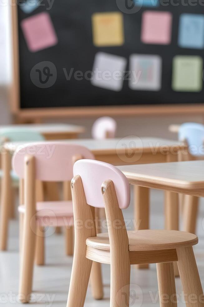 This primary school classroom features small wooden desks arranged neatly, with colorful posters adorning the walls. Soft lighting creates a warm and inviting atmosphere for students photo
