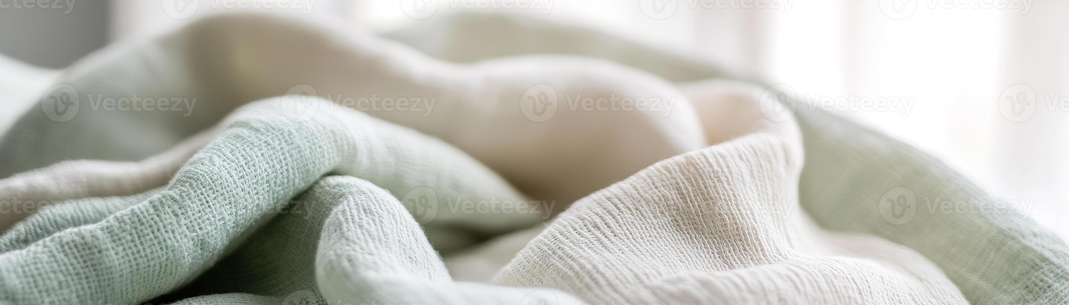 The soft green tones of textured fabric create a warm and inviting atmosphere. The blurred background emphasizes the coziness, ideal for eco-conscious designs photo