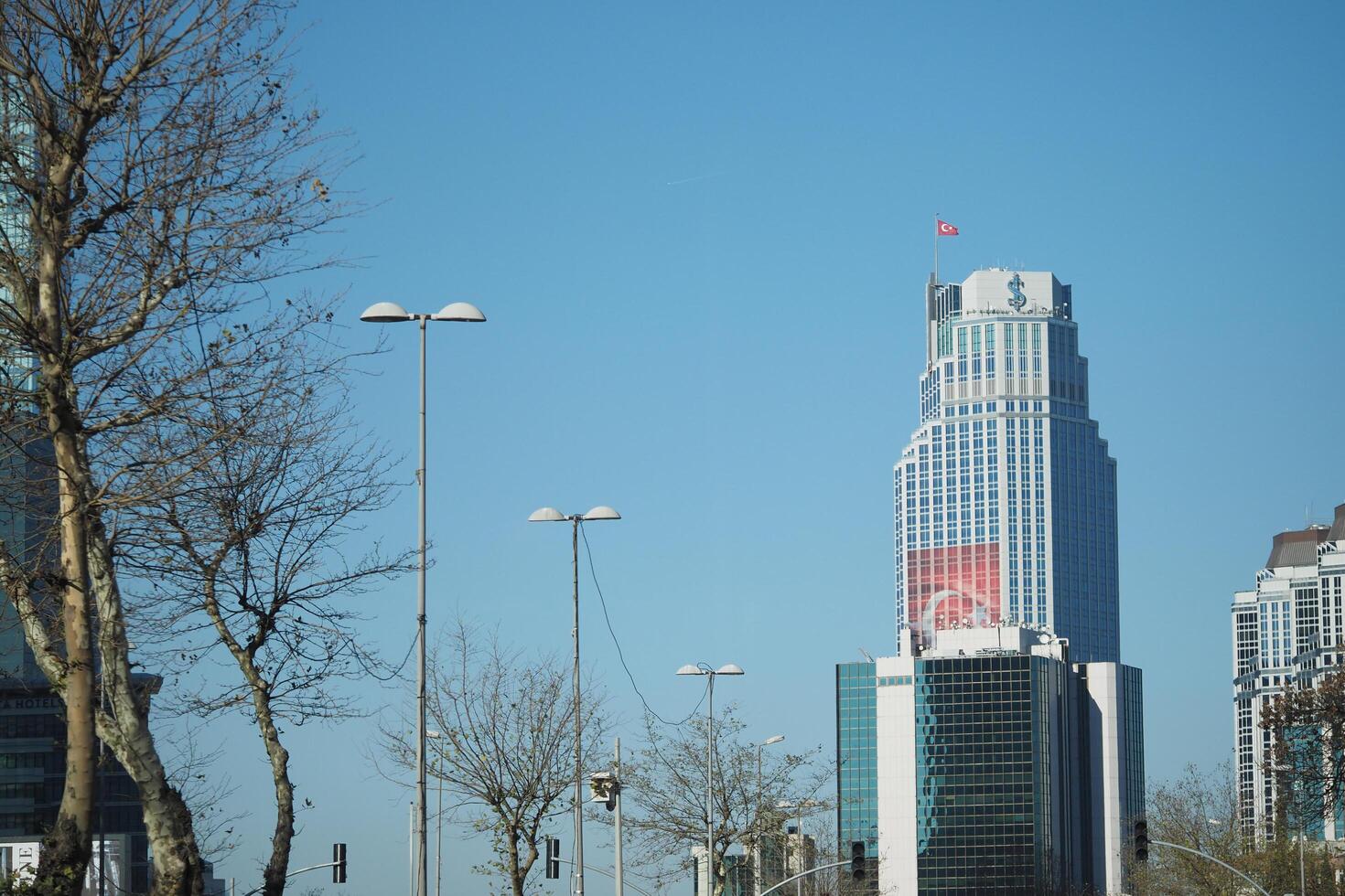 turkey istanbul 15 june 2024 Skyscraper with Turkish flag under clear blue sky photo