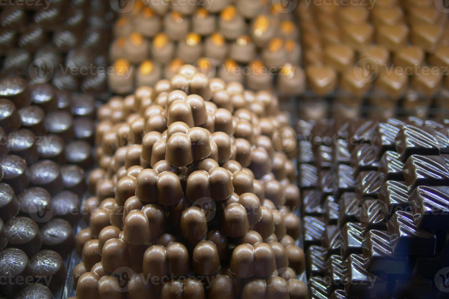 Chocolate confections stacked attractively in display case photo