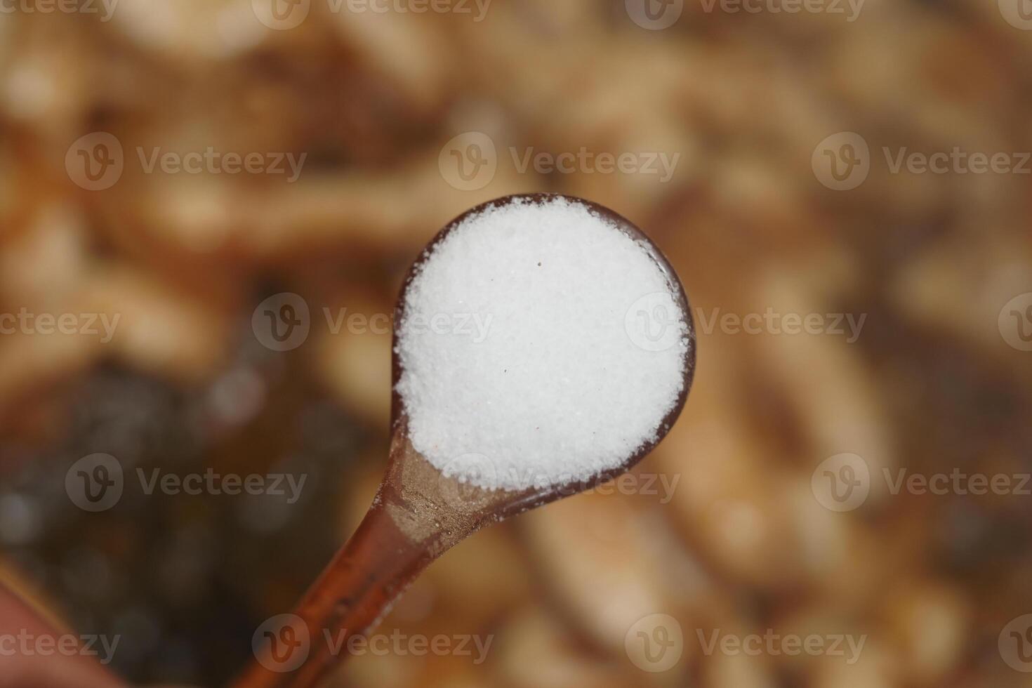 Salt being added to enhance flavors in a cooking process photo