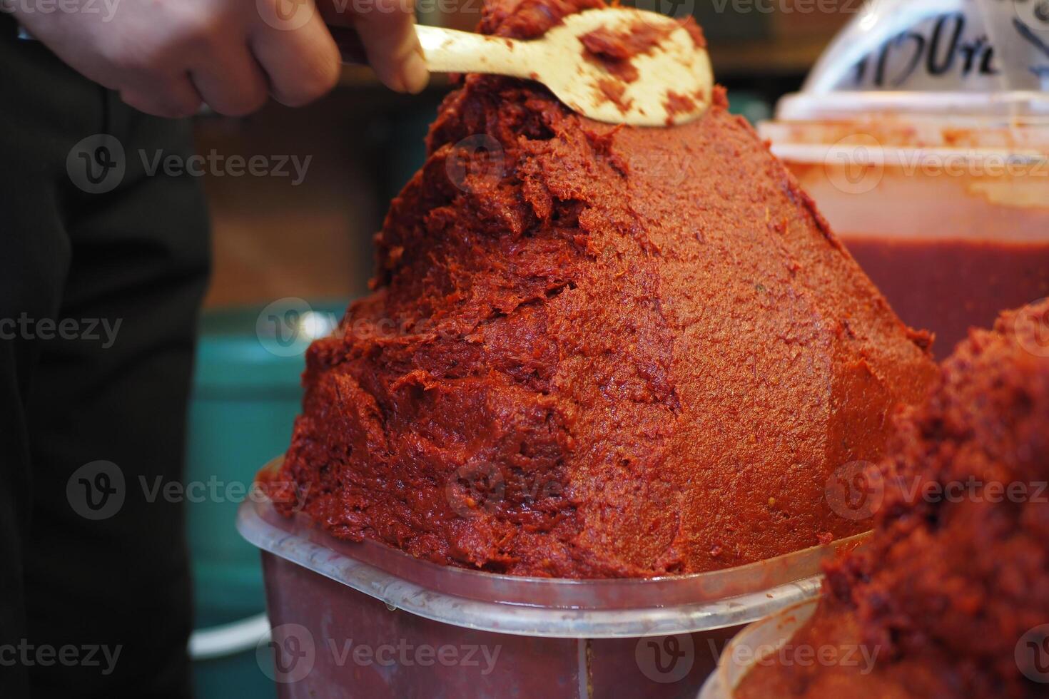 Spicy red pepper paste preparation at local market in autumn photo