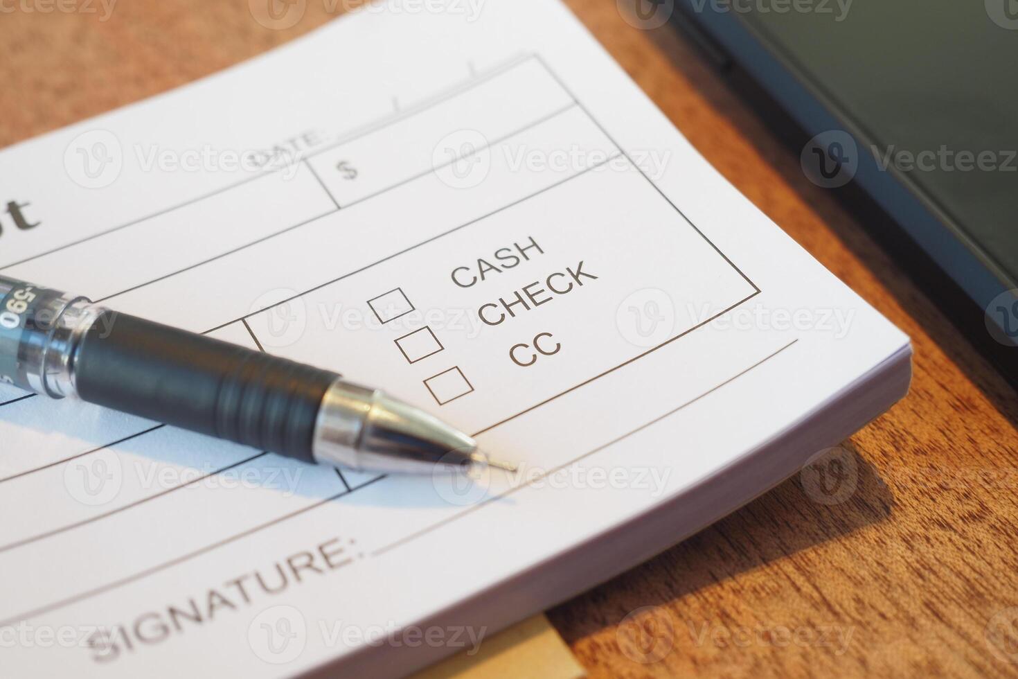 Payment options listed on a financial document with a pen photo