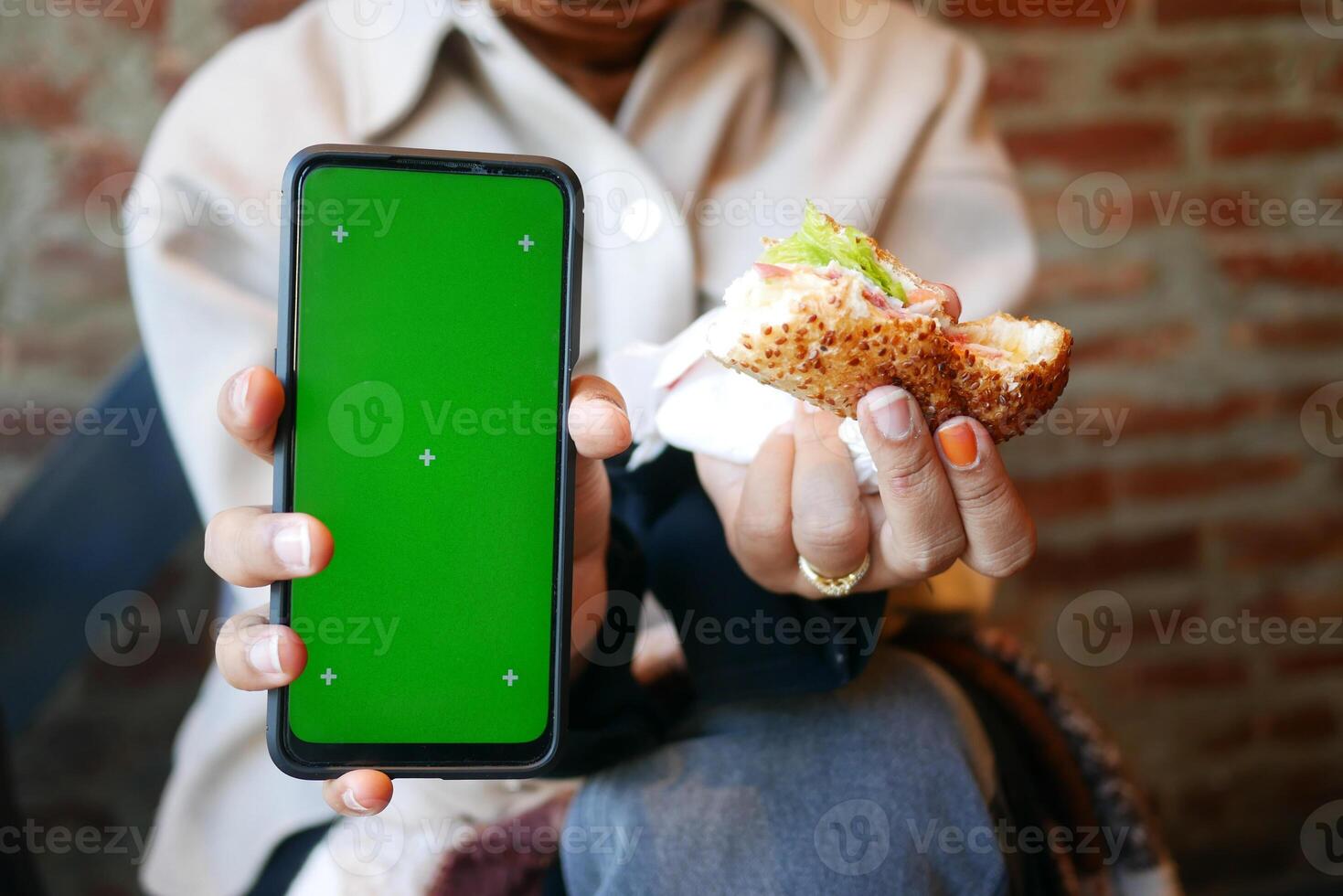 Enjoying a meal while capturing moments on a smartphone photo
