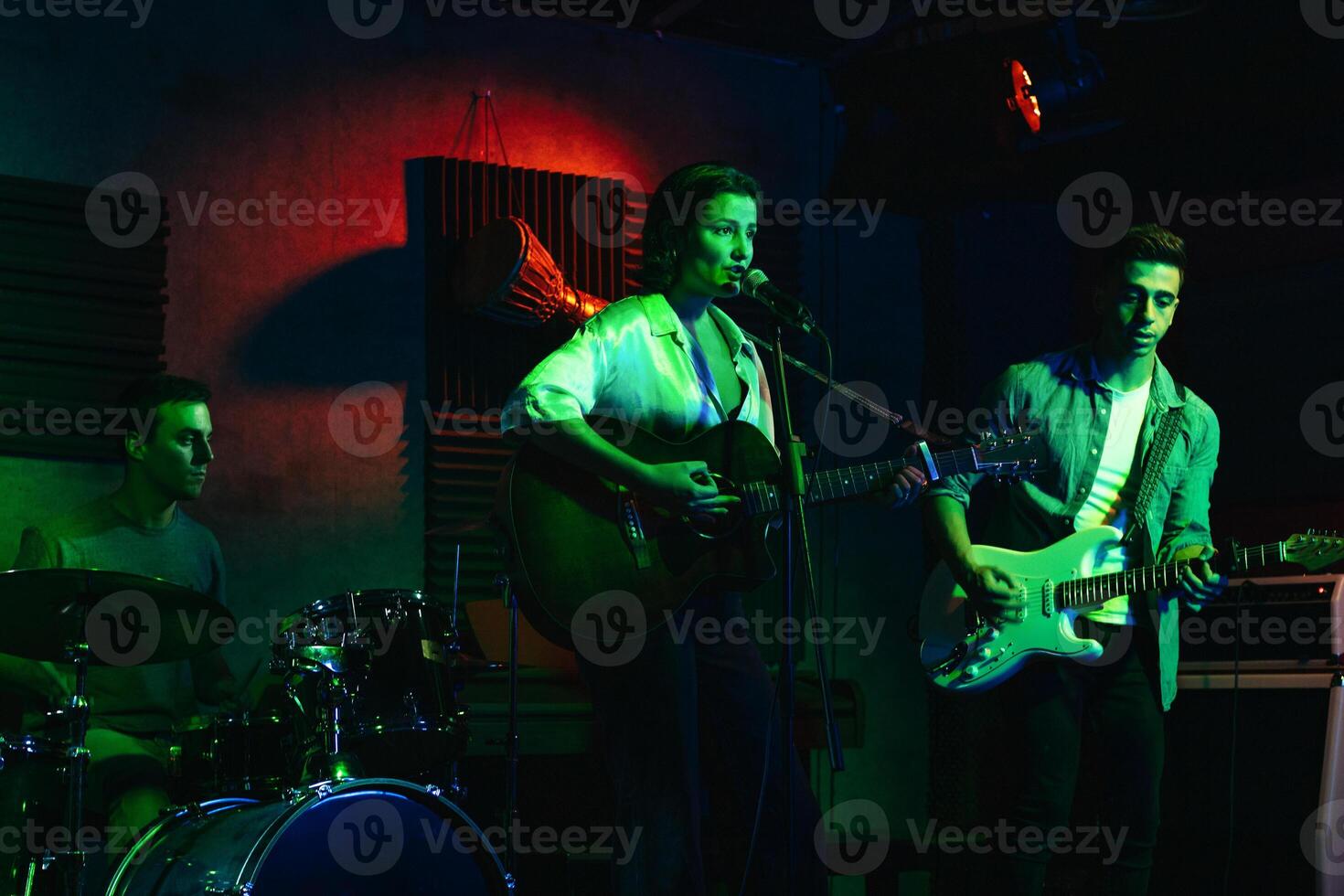 Musicians In Stage With Colorful Lights Performing In A Live Concert photo