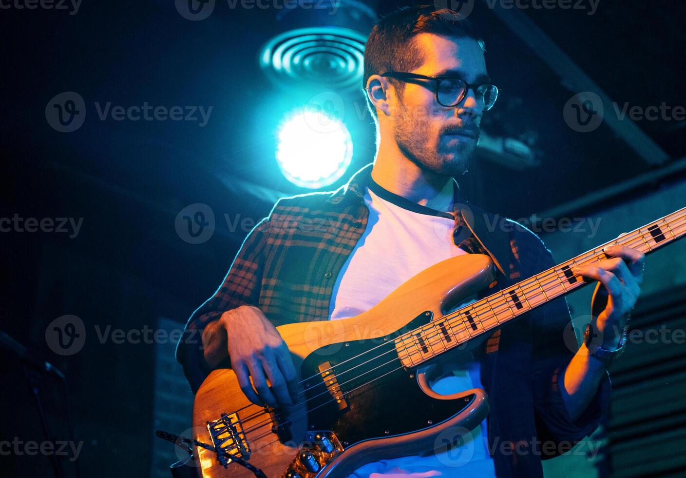 Bass Player In Stage With Colorful Lights photo