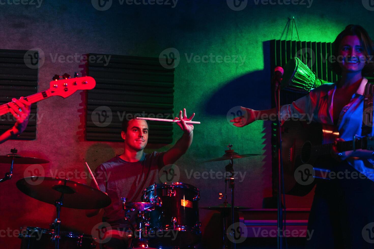 Musicians In Stage With Colorful Lights Performing In A Live Concert photo