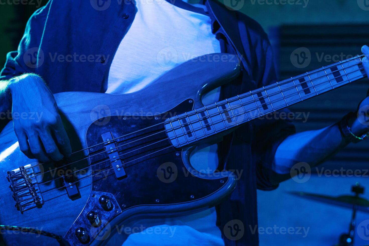 Bass Player Performing In A Live Concert photo