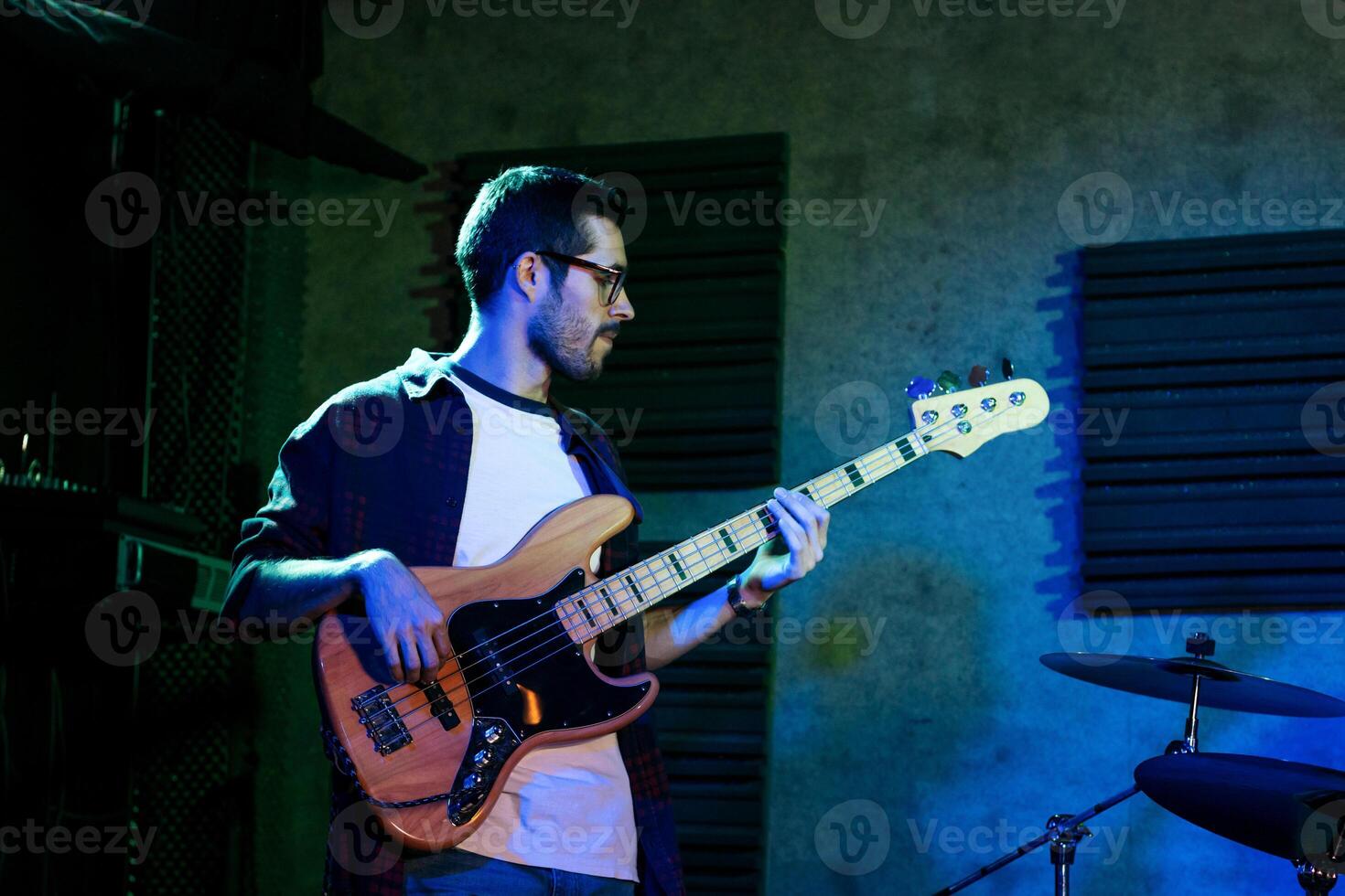 Bass Player In Stage With Colorful Lights photo