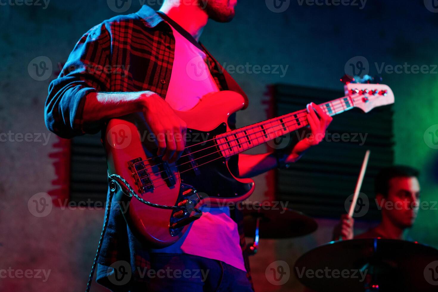 Bass Player In Stage With Colorful Lights photo