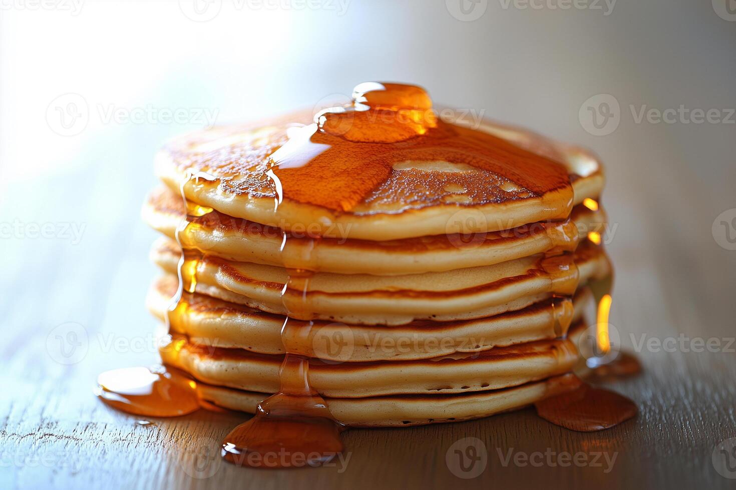 Golden pancakes stacked high, syrup cascading over fluffy layers, celebrating breakfast indulgence photo