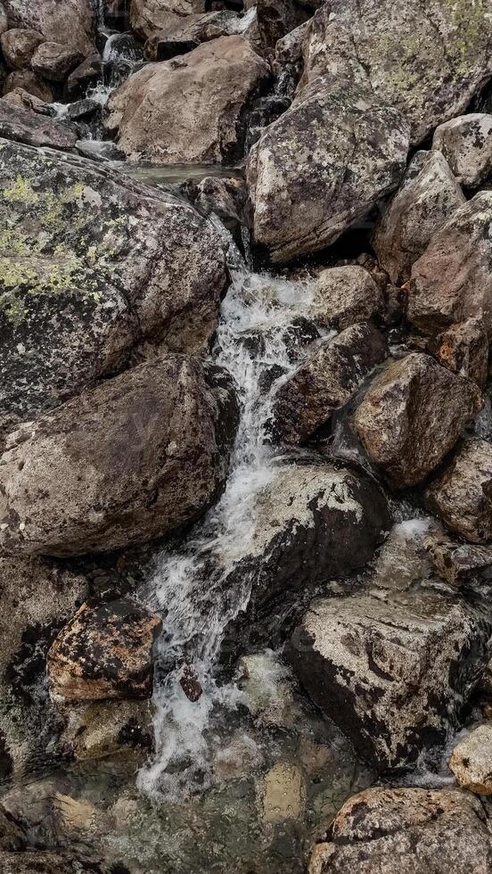 Water flowing down rocks in high tatras mountains, slovakia photo