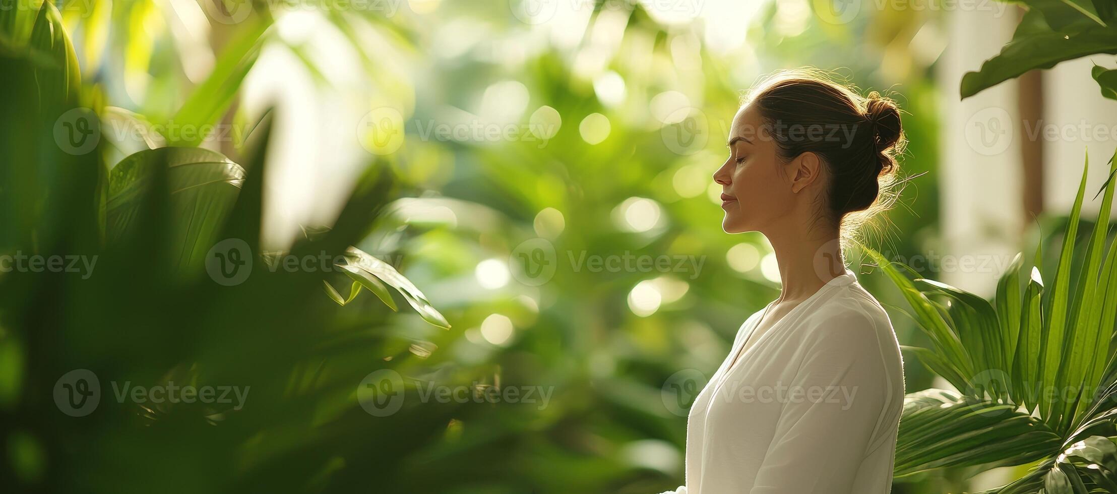 Relaxing spa self-care day concept. A woman meditates peacefully among lush greenery, radiating tranquility and mindfulness. photo