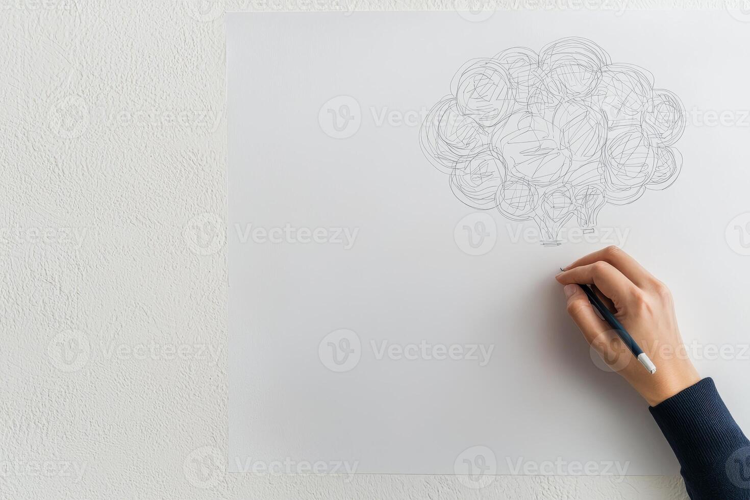 Startup brainstorming session concept. Person sketching a brain illustration on a blank paper surface. photo
