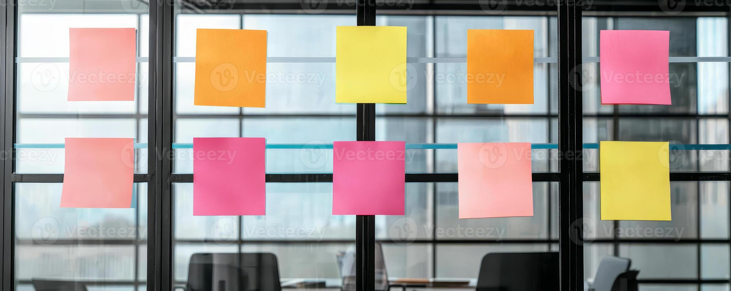 Startup brainstorming session concept. Colorful sticky notes arranged on a glass wall in a modern office setting. photo