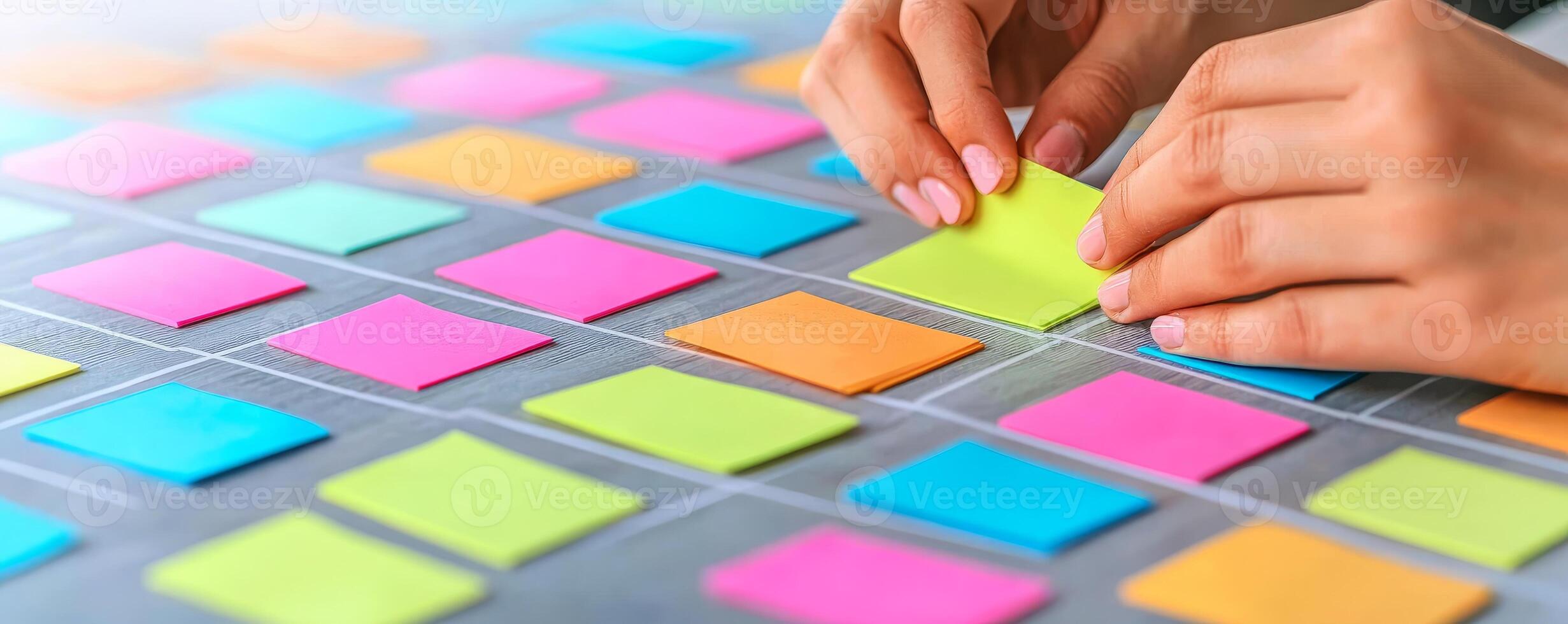 Project management coordination concept. Hands placing colorful sticky notes on a board for brainstorming or organizing ideas. photo