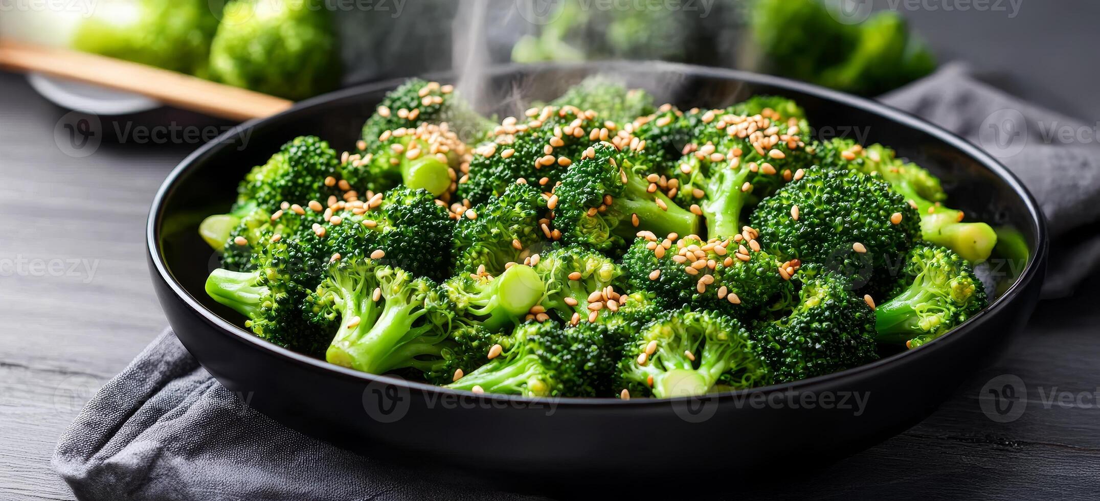 Broccoli stir-fry with sesame seeds concept. Freshly cooked broccoli garnished with sesame seeds in a stylish black bowl. photo